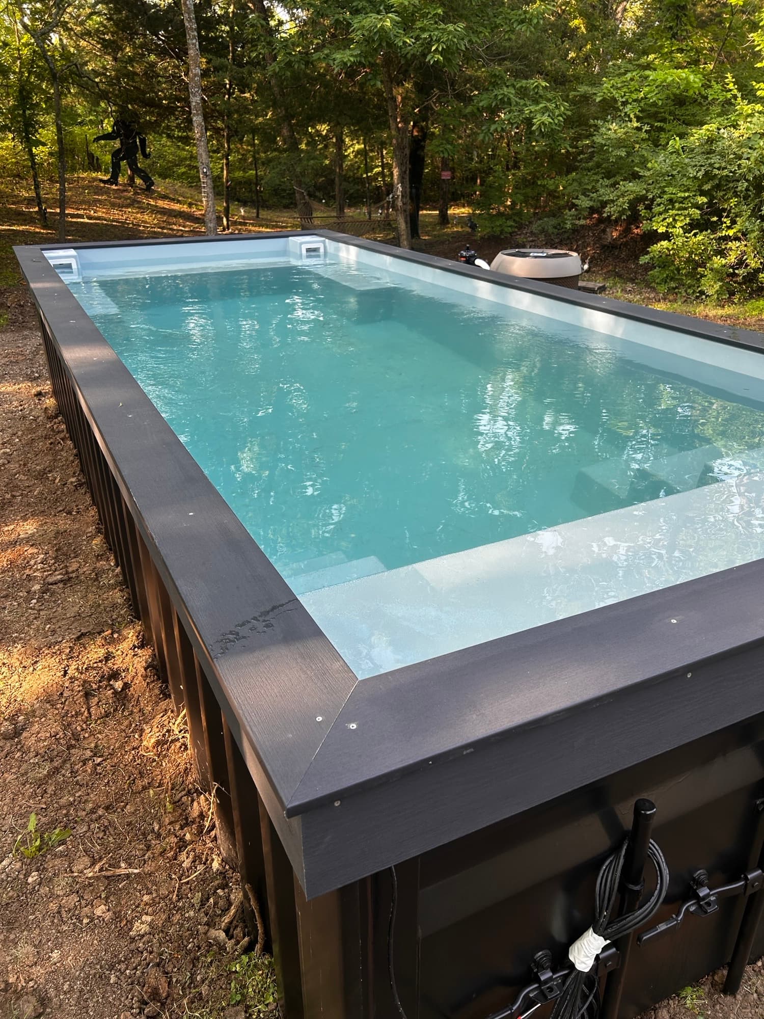 Fiberglass steps and tanning ledge inside a container pool